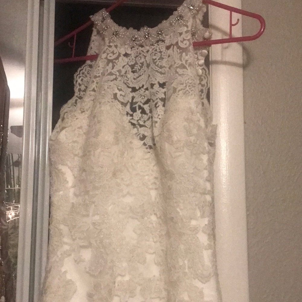 Almost brand new wedding dress.Worn for photos. Tiny bit of dirt on train.